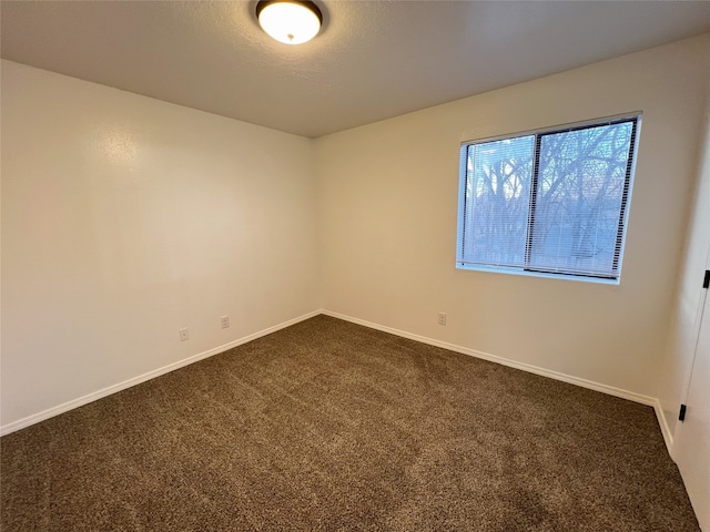 1666 Calle De Oriente Norte, Santa Fe, NM 87507 - empty room with baseboards, dark colored carpet, and a textured ceiling