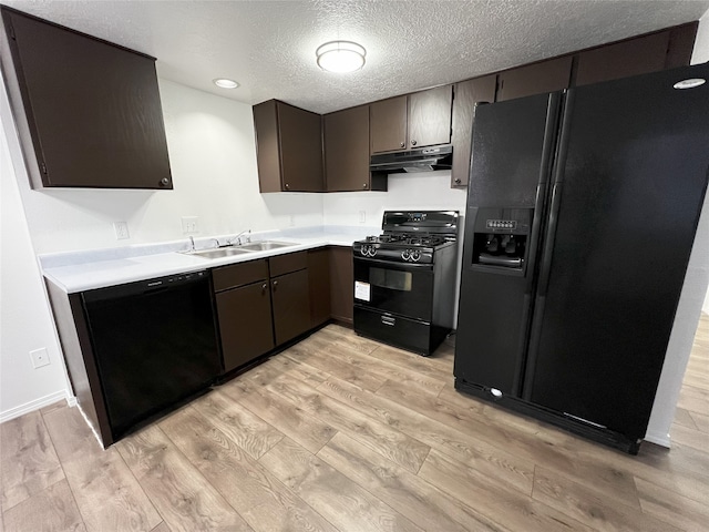 1666 Calle De Oriente Norte, Santa Fe, NM 87507 - kitchen featuring light wood finished floors, black appliances, under cabinet range hood, and a sink