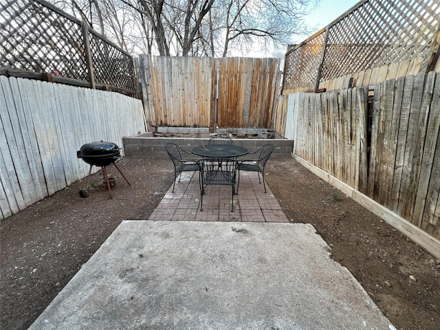 1666 Calle De Oriente Norte, Santa Fe, NM 87507 - view of patio / terrace with a grill, outdoor dining area, and a fenced backyard