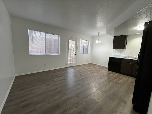 1666 Calle De Oriente Norte, Santa Fe, NM 87507 - interior space with a textured ceiling, a chandelier, baseboards, dark wood finished floors, and a sink