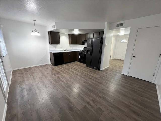 1666 Calle De Oriente Norte, Santa Fe, NM 87507 - kitchen with light countertops, a sink, visible vents, black appliances, and dark wood-style flooring