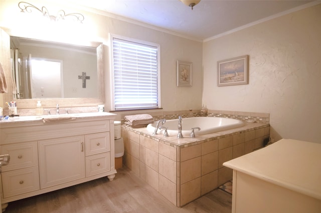 bathroom featuring vanity, wood finished floors, a garden tub, and crown molding