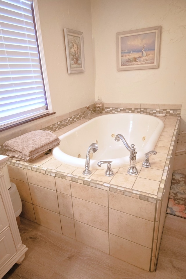 full bath with a tub with jets and toilet