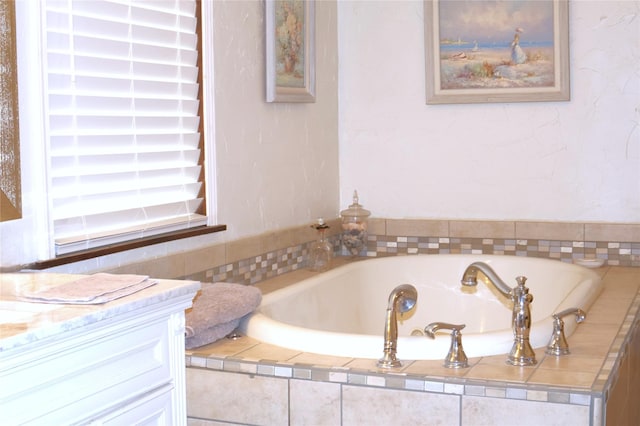full bath featuring a bath and vanity