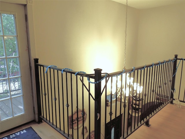 stairs featuring a wealth of natural light and wood finished floors