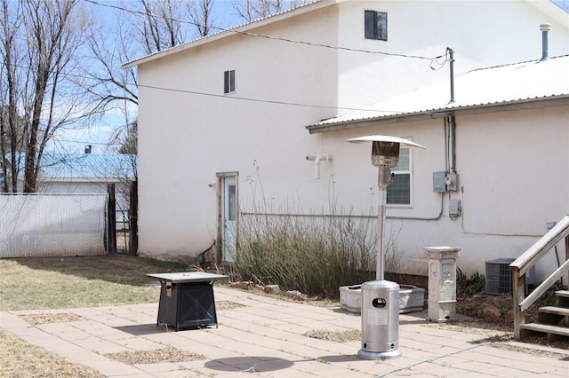 exterior space with fence and central AC unit
