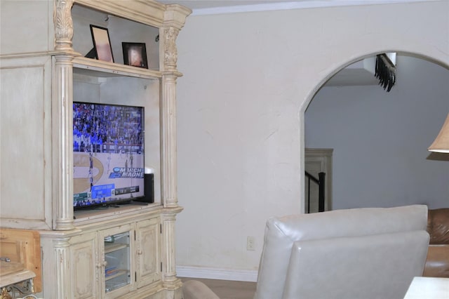 living room featuring arched walkways and baseboards