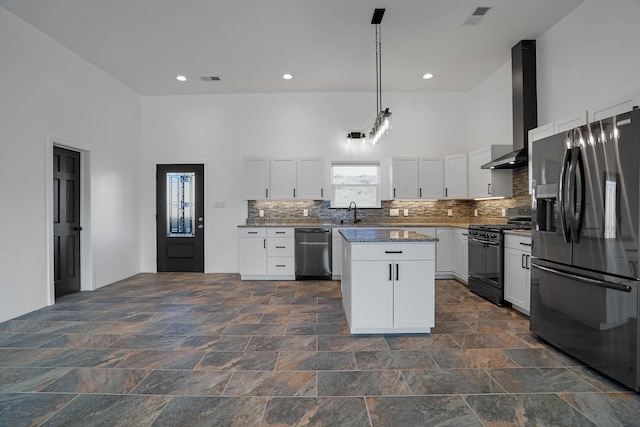 3 Cerro Cir, Lamy, NM 87540 - kitchen with white cabinetry, tasteful backsplash, stainless steel appliances, visible vents, and wall chimney exhaust hood