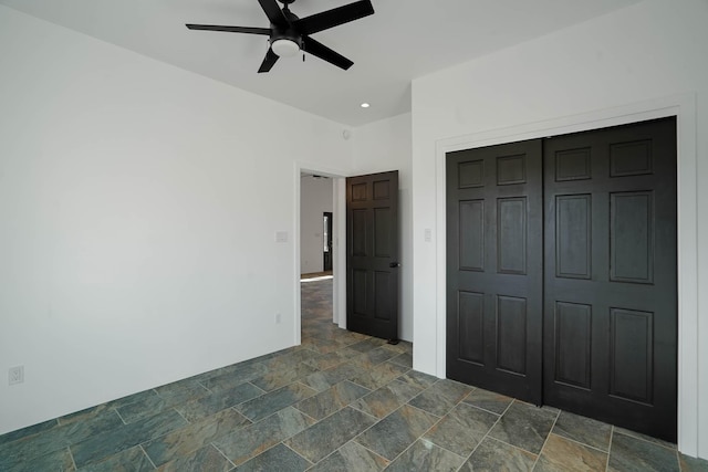 3 Cerro Cir, Lamy, NM 87540 - unfurnished bedroom with a closet, a ceiling fan, and stone finish flooring