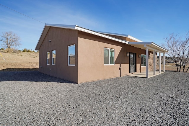 3 Cerro Cir, Lamy, NM 87540 - view of side of home featuring stucco siding and a patio