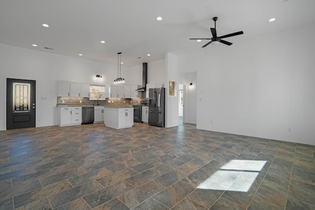 3 Cerro Cir, Lamy, NM 87540 - kitchen featuring open floor plan, tasteful backsplash, white cabinets, a ceiling fan, and appliances with stainless steel finishes