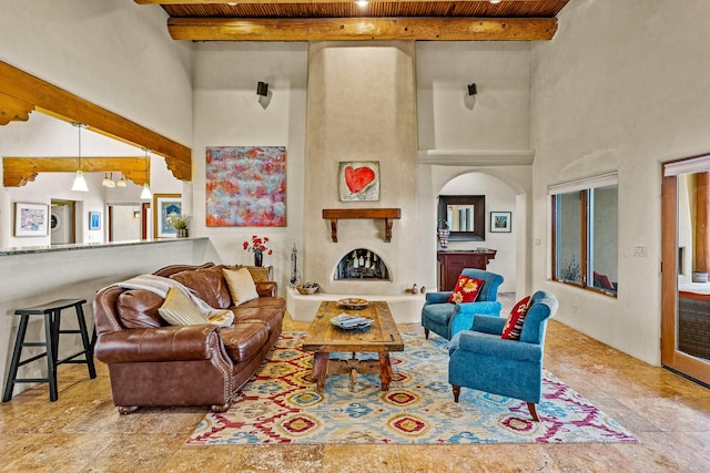 living room with arched walkways, a high ceiling, beam ceiling, and wood ceiling