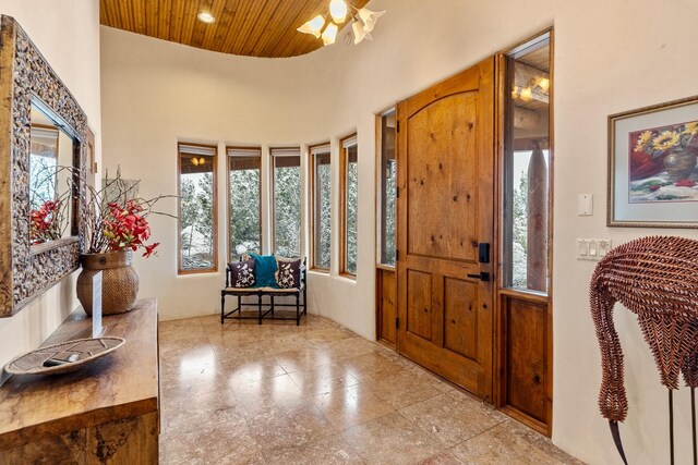 foyer entrance featuring a wealth of natural light, a high ceiling, wooden ceiling, and recessed lighting
