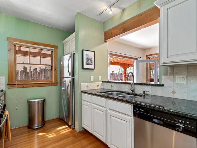 936 Dunlap, Santa Fe, NM 87501 - kitchen with stainless steel appliances, light wood finished floors, backsplash, white cabinets, and dark stone counters