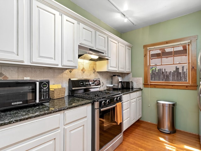 936 Dunlap, Santa Fe, NM 87501 - kitchen featuring stainless steel range with gas cooktop, under cabinet range hood, black microwave, white cabinets, and decorative backsplash
