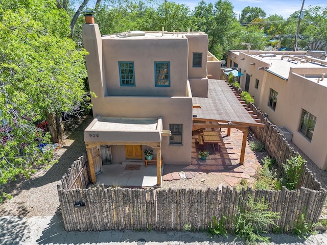 936 Dunlap, Santa Fe, NM 87501 - view of front of property with stucco siding, a chimney, and a patio area
