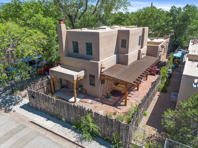 936 Dunlap, Santa Fe, NM 87501 - adobe home featuring a chimney, stucco siding, and a patio