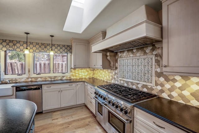 126 Andanada, Los Alamos, NM 87544 - kitchen featuring dark countertops, decorative backsplash, custom exhaust hood, and stainless steel appliances