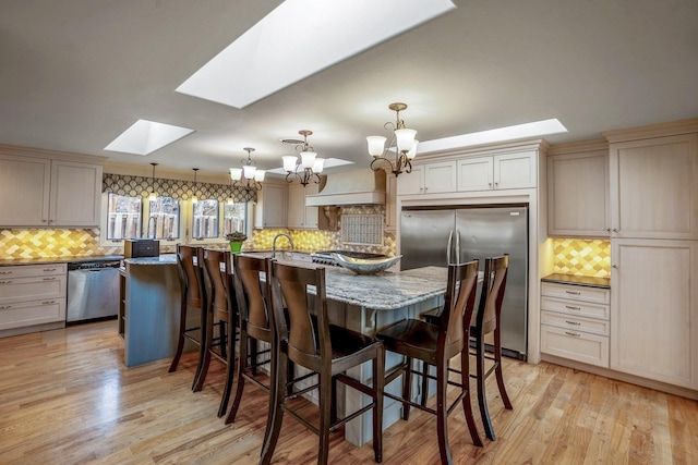 126 Andanada, Los Alamos, NM 87544 - dining room with a chandelier, light wood-type flooring, and a skylight