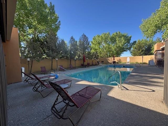 941 Calle Mejia Unit 207, Santa Fe, NM 87501 - community pool featuring a fenced backyard and a patio area