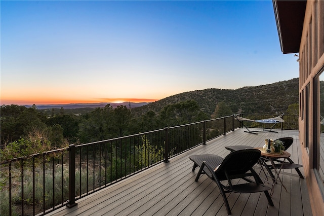 6 Overlook Rd, Santa Fe, NM 87505 - deck at dusk with a forest view and a mountain view