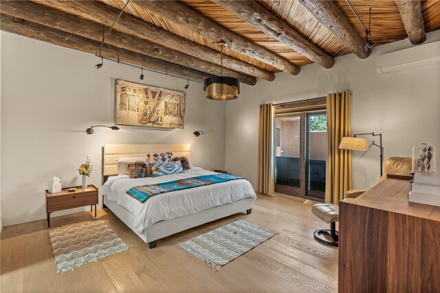 6 Overlook Rd, Santa Fe, NM 87505 - bedroom featuring a wall mounted air conditioner, beamed ceiling, wood finished floors, access to exterior, and wooden ceiling