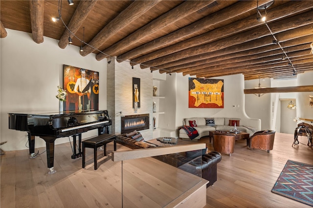 6 Overlook Rd, Santa Fe, NM 87505 - living room with beamed ceiling, wood finished floors, wooden ceiling, and a fireplace
