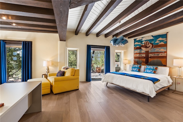 6 Overlook Rd, Santa Fe, NM 87505 - bedroom with access to exterior, wood finished floors, multiple windows, and beamed ceiling
