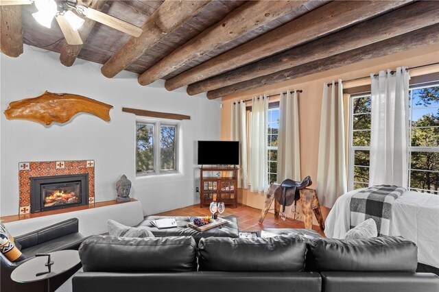 6 Overlook Rd, Santa Fe, NM 87505 - living area with a tiled fireplace, tile patterned floors, beamed ceiling, and ceiling fan