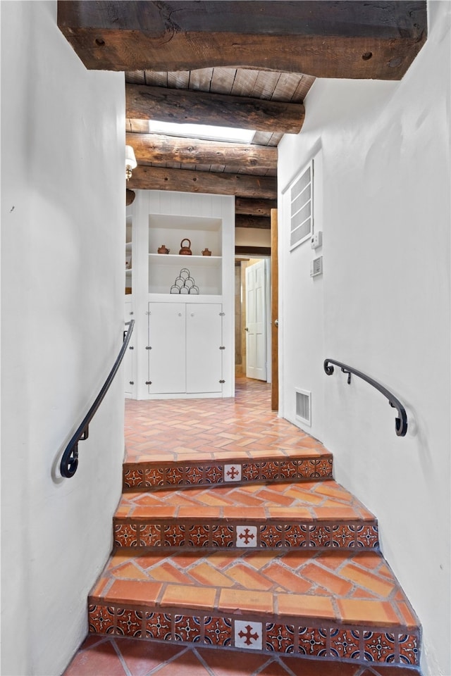 6 Overlook Rd, Santa Fe, NM 87505 - stairway featuring visible vents, built in features, beam ceiling, and wood ceiling