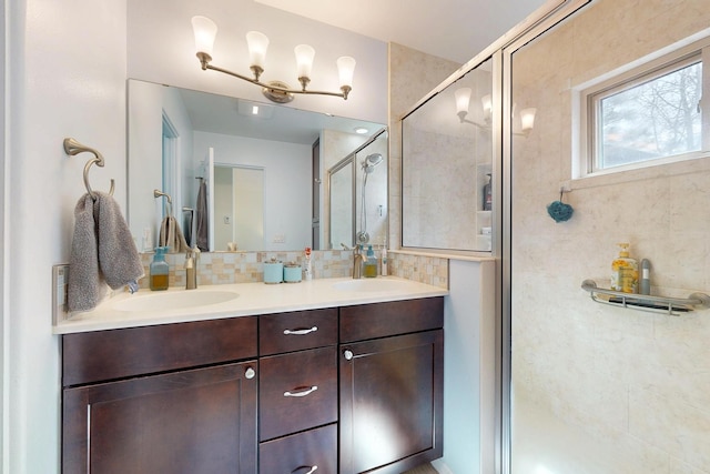 full bathroom with a shower stall, double vanity, backsplash, and a sink