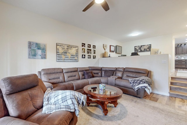 living room with wood finished floors and ceiling fan