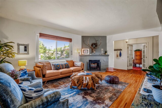 908 Rio Vista St, Santa Fe, NM 87501 - living area with baseboards, a large fireplace, and wood finished floors