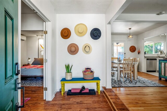 908 Rio Vista St, Santa Fe, NM 87501 - corridor with baseboards, a wall mounted AC, wood finished floors, and a sink