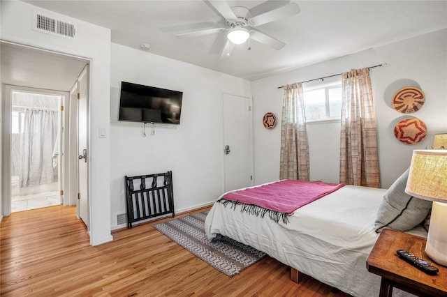 908 Rio Vista St, Santa Fe, NM 87501 - bedroom featuring visible vents, light wood-style floors, ceiling fan, and ensuite bath