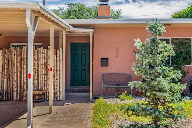 908 Rio Vista St, Santa Fe, NM 87501 - property entrance featuring stucco siding and a chimney