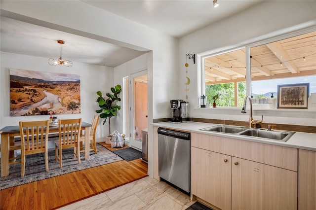 908 Rio Vista St, Santa Fe, NM 87501 - kitchen featuring light countertops, a sink, pendant lighting, a chandelier, and stainless steel dishwasher