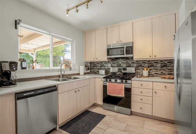 908 Rio Vista St, Santa Fe, NM 87501 - kitchen with backsplash, light countertops, a sink, and appliances with stainless steel finishes