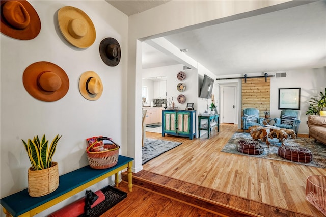 908 Rio Vista St, Santa Fe, NM 87501 - living room featuring visible vents, a barn door, and wood finished floors