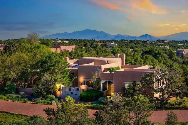 24 Paintbrush Cir, Santa Fe, NM 87506 - view of front of property featuring stucco siding and a mountain view