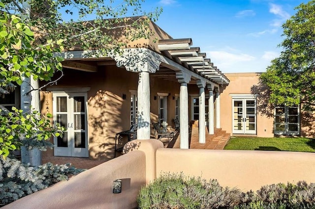 24 Paintbrush Cir, Santa Fe, NM 87506 - entrance to property featuring french doors and stucco siding