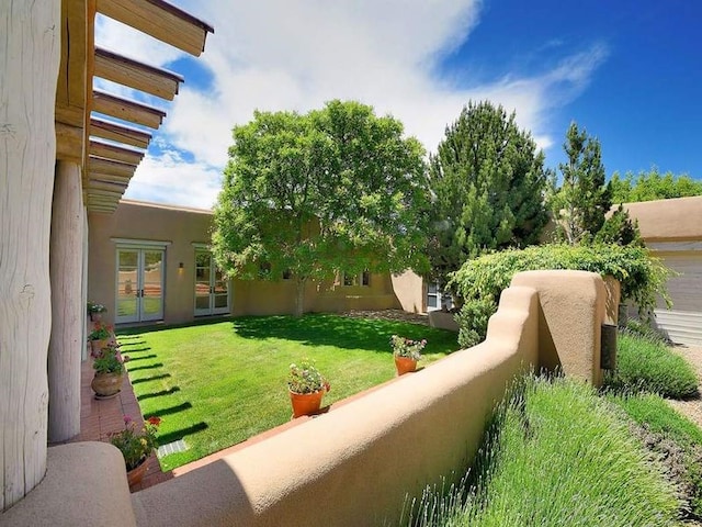 24 Paintbrush Cir, Santa Fe, NM 87506 - view of grassy yard featuring french doors and a balcony