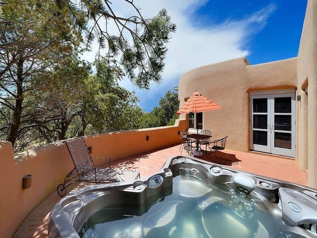 24 Paintbrush Cir, Santa Fe, NM 87506 - view of patio / terrace with french doors and a hot tub