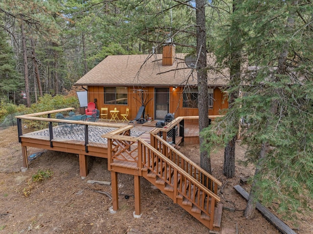 exterior space featuring a view of trees and a deck