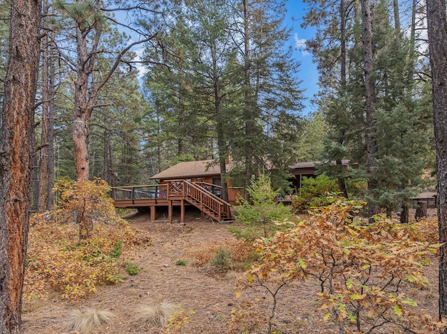 back of property featuring a deck and stairs