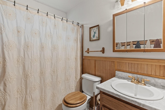 bathroom with vanity, a wainscoted wall, toilet, wood walls, and a shower with shower curtain