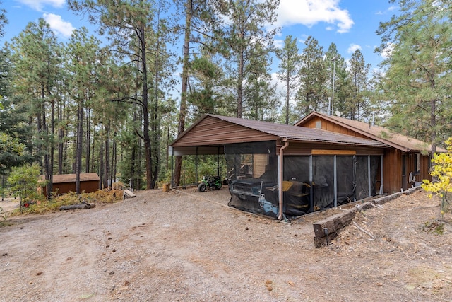 view of outbuilding with a detached carport