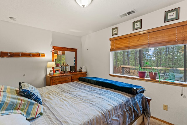 bedroom featuring baseboards, carpet, and visible vents