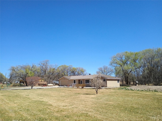 exterior space featuring a garage and a front yard