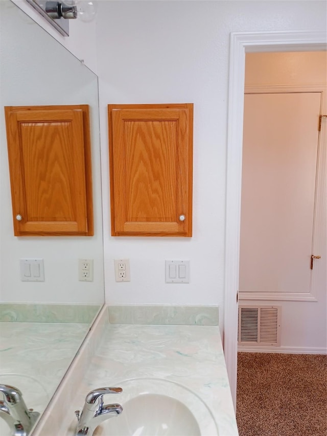 bathroom with vanity and visible vents